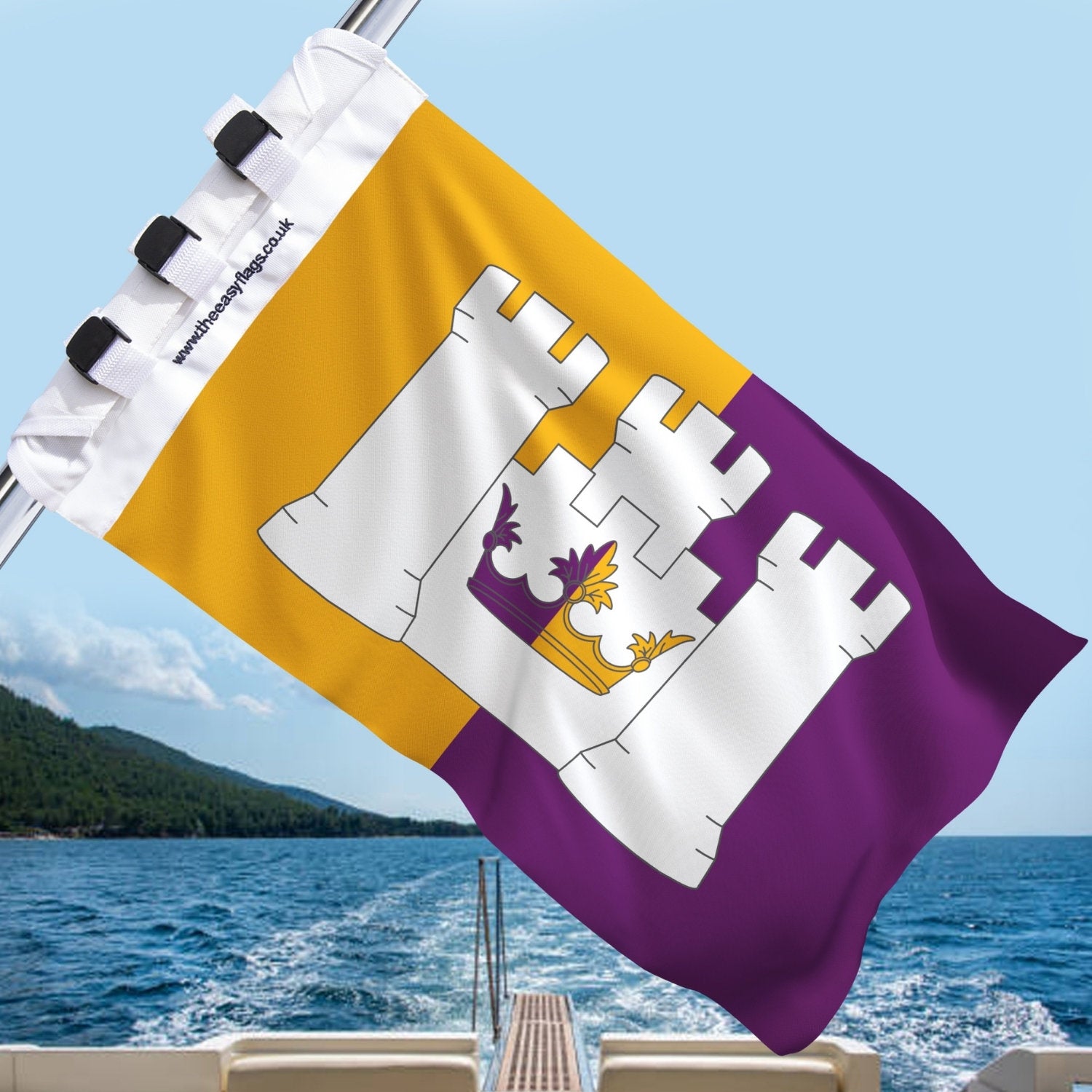 Aberdeenshire county flag with gold and purple background, featuring a white triple-towered castle and crown emblem, mounted on a boat rail with a universal triple-lock system, flying at sea with blue sky and coastline in the background