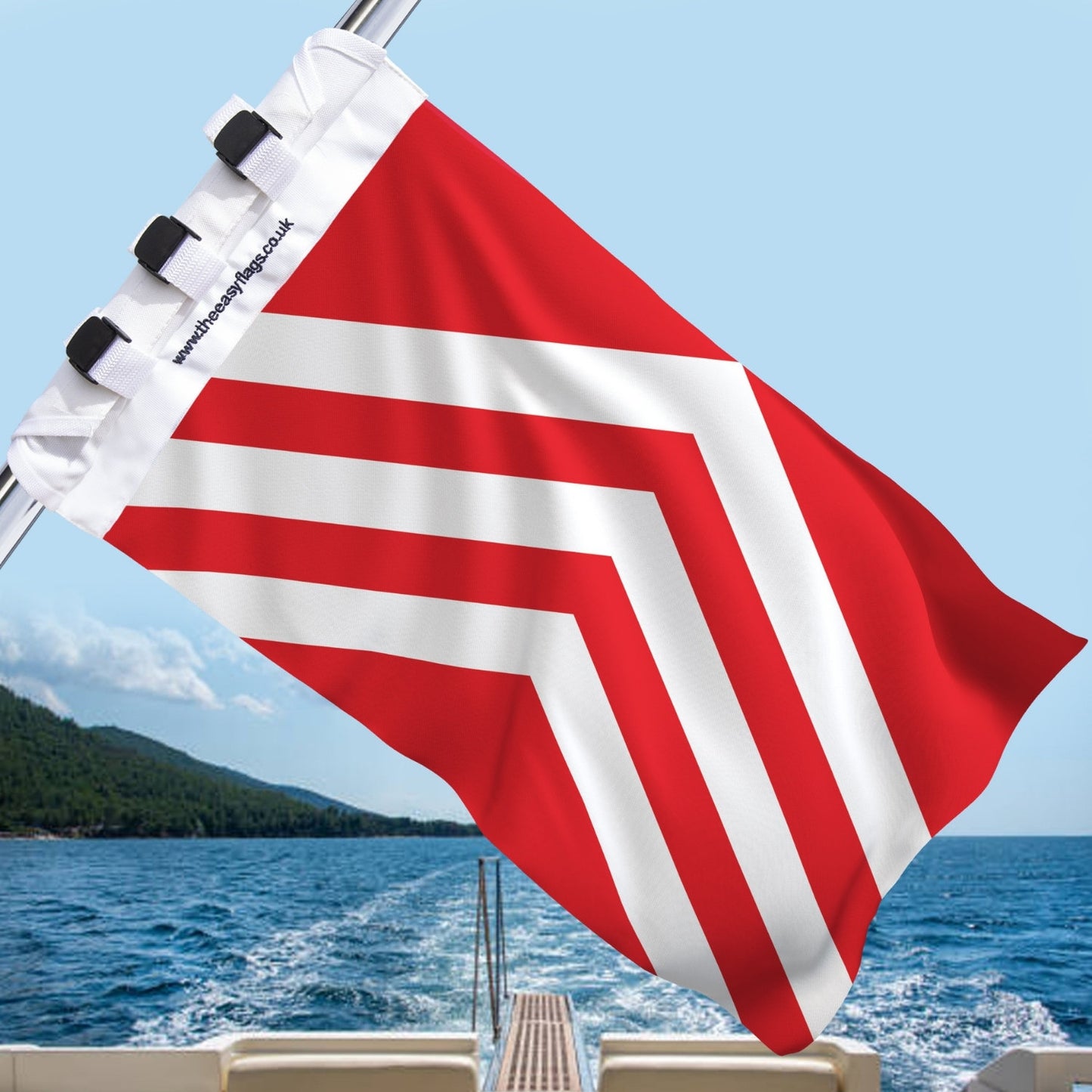 Glamorgan county flag with white chevrons, mounted on a boat rail with a universal triple-lock system, flying at sea with blue sky and coastline in the background