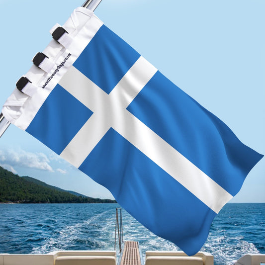 Shetland Islands county flag with blue background and white Nordic cross, mounted on a boat rail with a universal triple-lock system, flying at sea with blue sky and coastline in the background